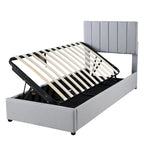 Eenpersoons hydraulisch opbergbed met gestoffeerd gestreept hoofdbord